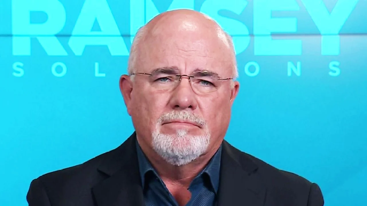 Dave Ramsey seated in front of a Ramsey Solutions backdrop